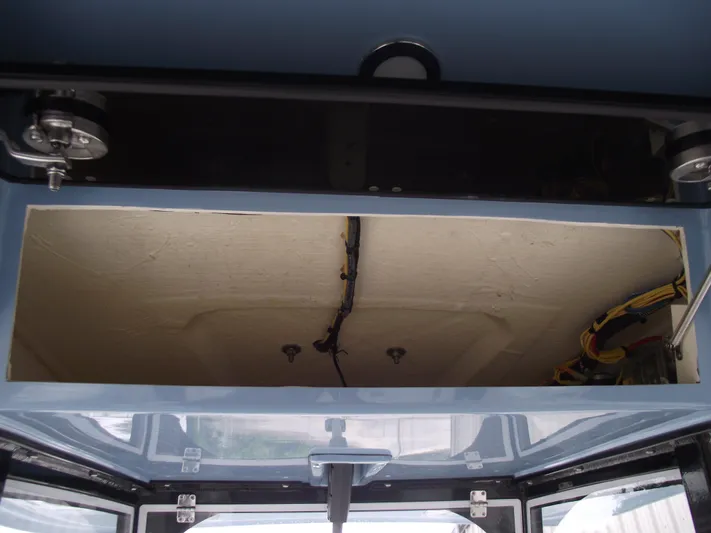  Yacht Photos Pics 2021 Cobia 301 Center Console storage compartment with wiring visible.