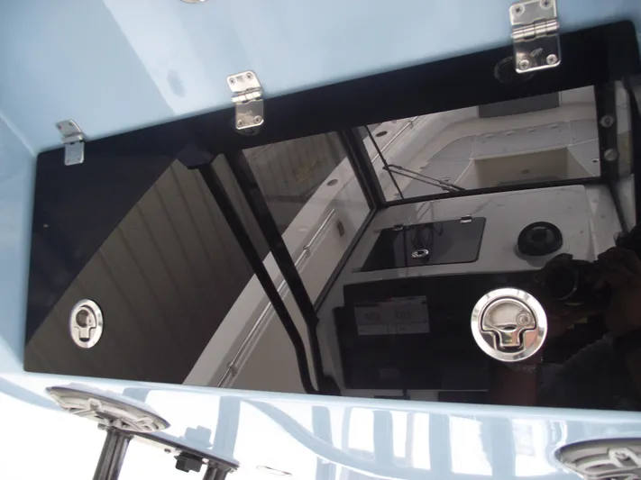  Yacht Photos Pics 2021 Cobia 301 Center Console boat interior with sleek black panel and metallic fixtures.