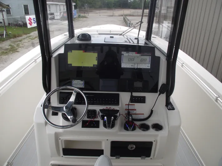  Yacht Photos Pics 2021 Cobia 301 Center Console boat dashboard with steering wheel and electronic displays.