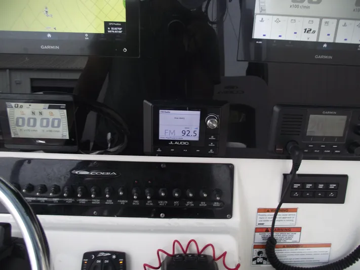  Yacht Photos Pics 2021 Cobia 301 Center Console dashboard with Garmin displays and JL Audio system.