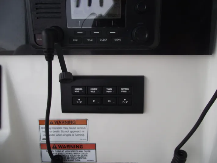  Yacht Photos Pics Control panel of a 2021 Cobia 301 Center Console boat with warning labels.