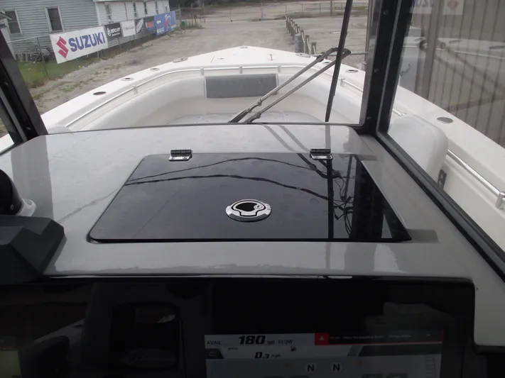  Yacht Photos Pics 2021 Cobia 301 Center Console boat dashboard with navigation controls and windshield view.