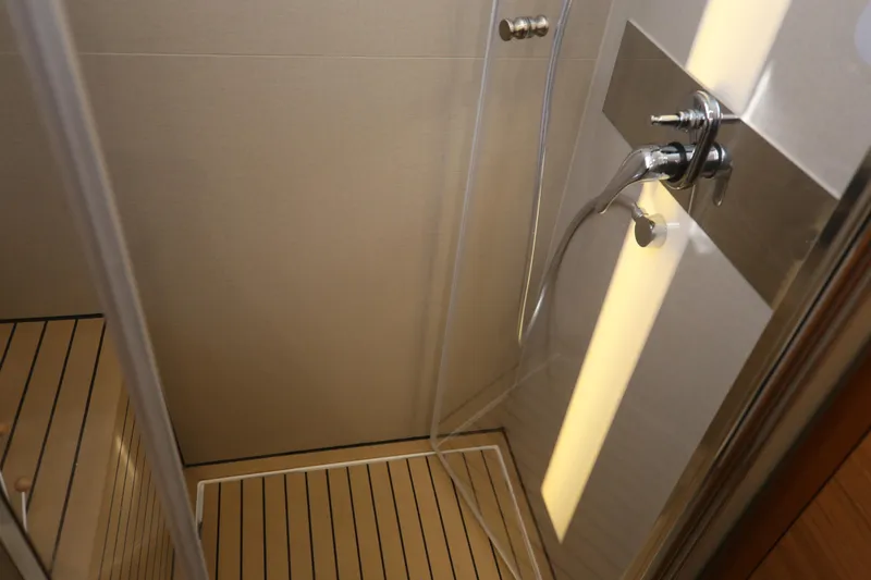  Yacht Photos Pics Shower area in 2023 Greenline 45 Coupe yacht with modern fixtures and wooden flooring.