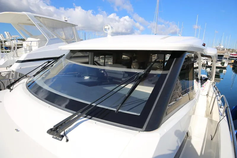  Yacht Photos Pics 2023 Greenline 45 Coupe yacht with sleek design, docked in a marina under blue skies.