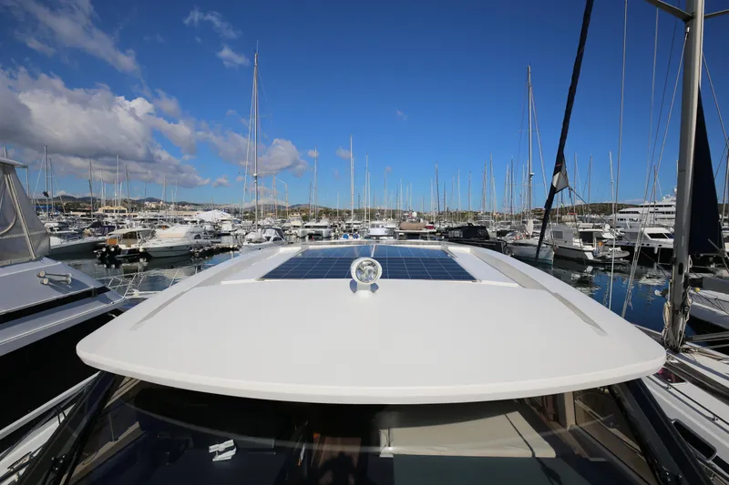  Yacht Photos Pics 2023 Greenline 45 Coupe yacht with solar panels, docked in a marina under clear blue skies.