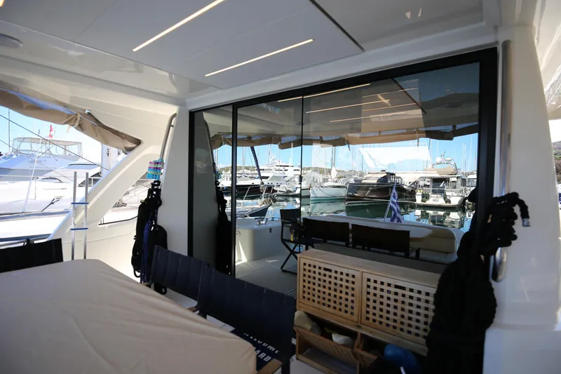  Yacht Photos Pics 2023 Greenline 45 Coupe yacht interior with marina view through large windows.