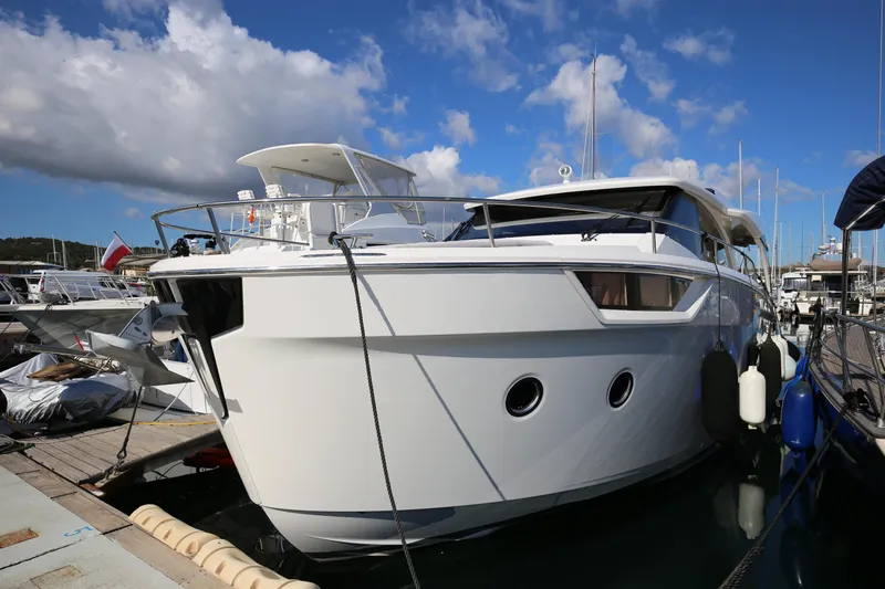  Yacht Photos Pics 2023 Greenline 45 Coupe yacht docked at marina under blue sky.
