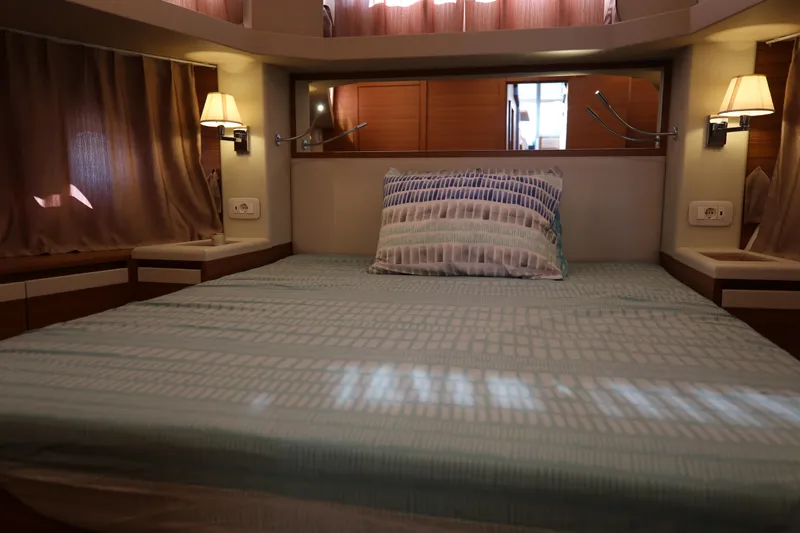  Yacht Photos Pics Luxurious bedroom interior of 2023 Greenline 45 Coupe yacht with elegant lighting and decor.