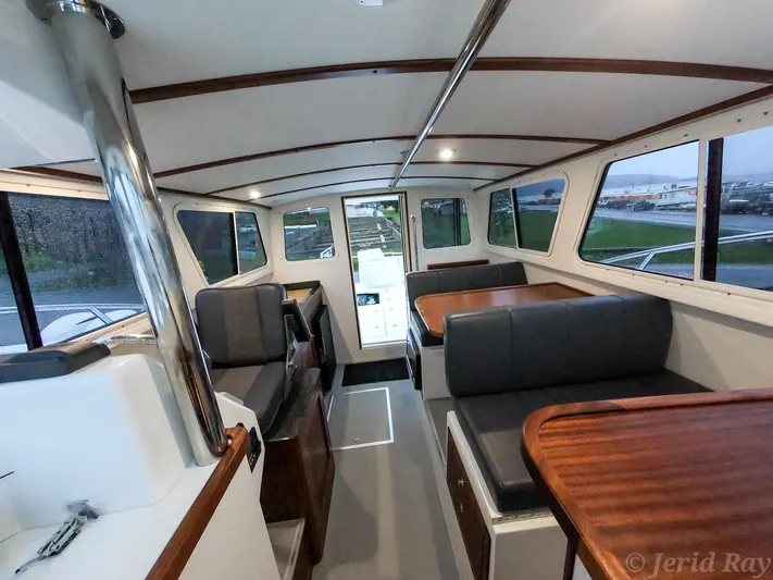  Yacht Photos Pics Interior of 2025 Ocean Sport Roamer boat with seating and tables.