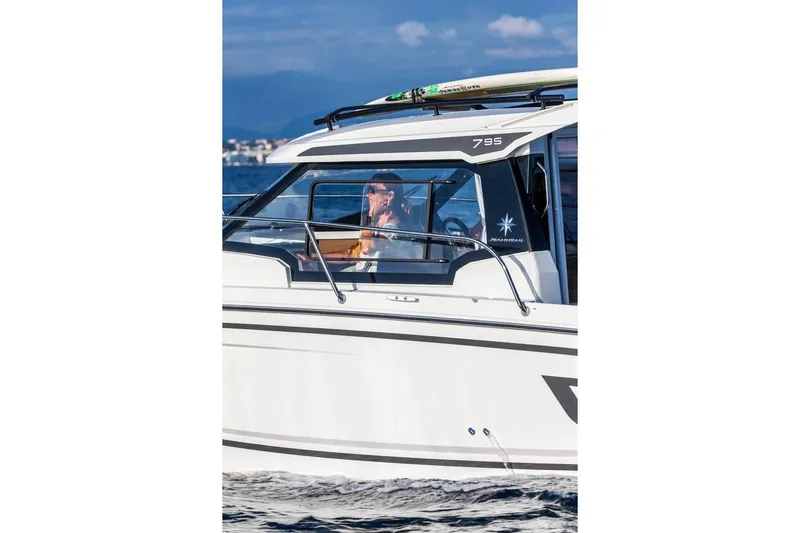  Yacht Photos Pics 2026 Jeanneau NC 795 Series 2 boat cruising on water, side view.