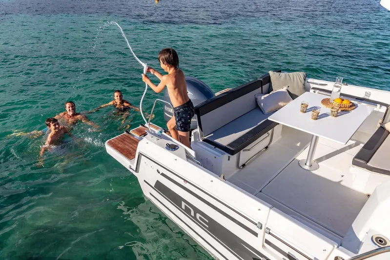  Yacht Photos Pics 2026 Jeanneau NC 795 Series 2 boat with people enjoying water activities.