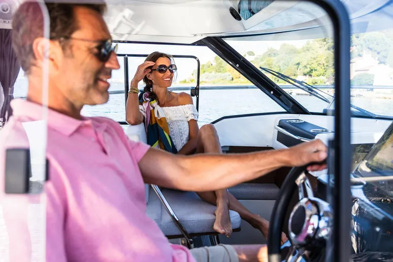  Yacht Photos Pics Couple enjoying a ride on a 2026 Jeanneau NC 795 Series 2 boat.