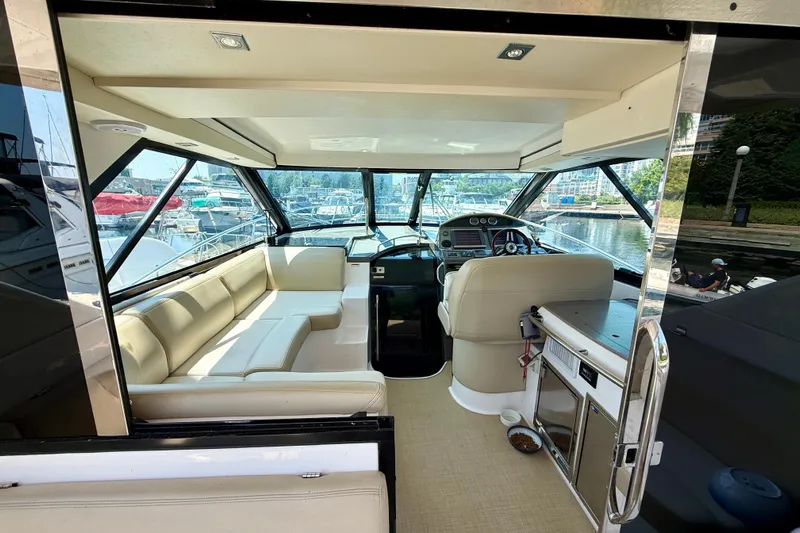  Yacht Photos Pics Interior of 2012 Regal 42 Sport Coupe yacht with beige seating and helm station.