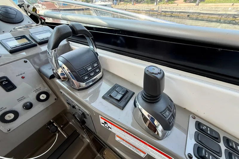  Yacht Photos Pics Control panel of a 2012 Regal 42 Sport Coupe boat, featuring throttle and joystick controls.