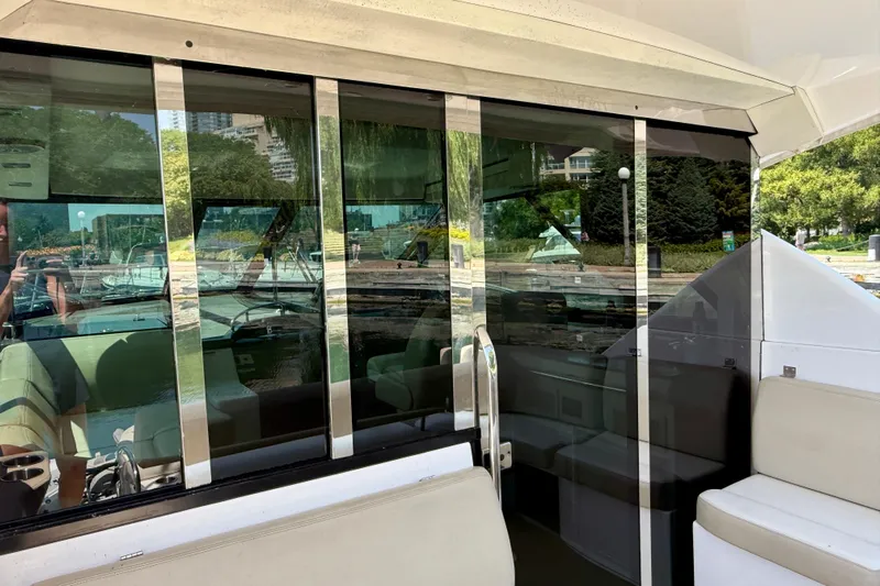  Yacht Photos Pics 2012 Regal 42 Sport Coupe yacht interior with reflective glass and beige seating.