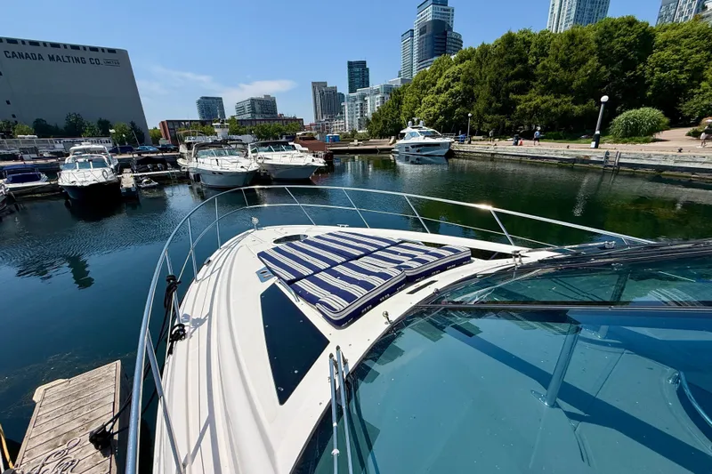  Yacht Photos Pics 2012 Regal 42 Sport Coupe docked in urban marina with city skyline.