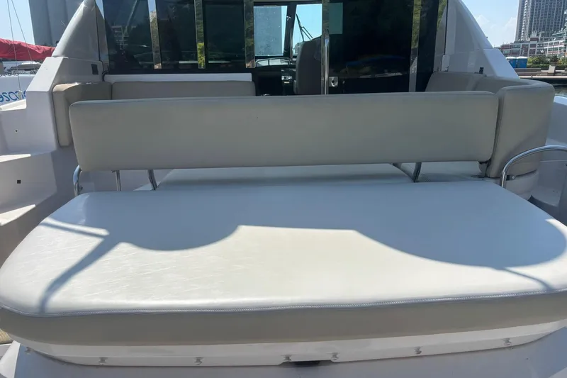  Yacht Photos Pics Rear seating area of a 2012 Regal 42 Sport Coupe boat, featuring cushioned seats.