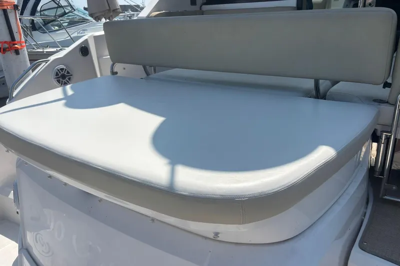  Yacht Photos Pics 2012 Regal 42 Sport Coupe boat seating area with cushioned bench and backrest.