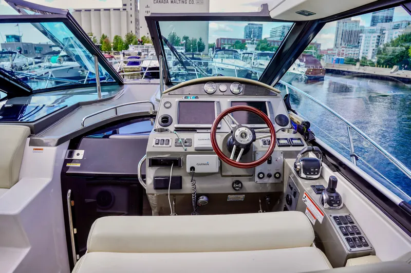  Yacht Photos Pics Cockpit of 2012 Regal 42 Sport Coupe yacht with modern navigation equipment.