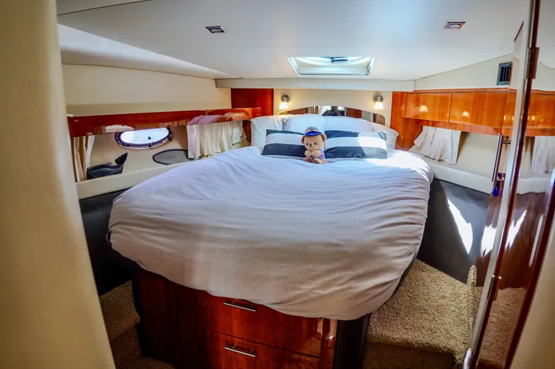  Yacht Photos Pics Luxurious bedroom interior of 2012 Regal 42 Sport Coupe yacht with plush bedding.