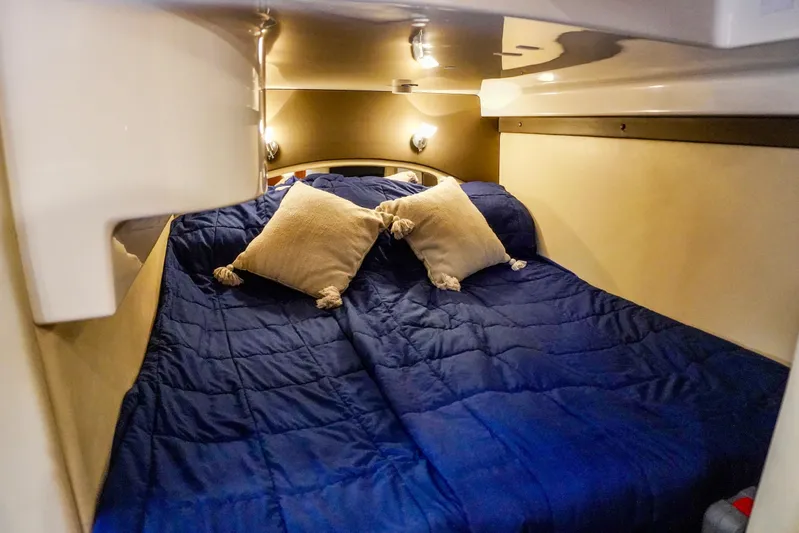 Yacht Photos Pics Cozy cabin interior of 2012 Regal 42 Sport Coupe with blue bedding and pillows.
