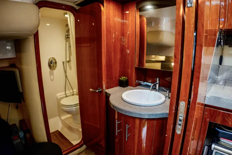  Yacht Photos Pics Luxurious bathroom interior of 2012 Regal 42 Sport Coupe yacht with wooden finishes.