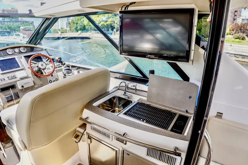  Yacht Photos Pics Interior of 2012 Regal 42 Sport Coupe with helm, sink, grill, and TV.