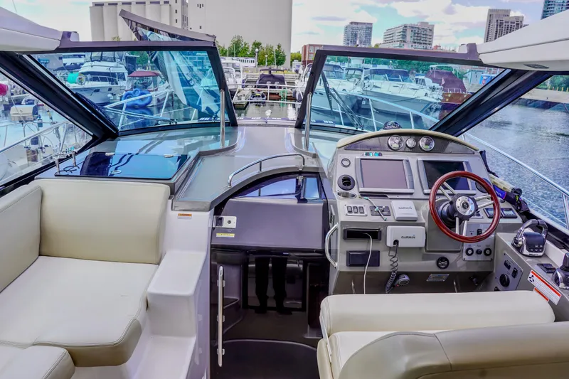  Yacht Photos Pics 2012 Regal 42 Sport Coupe yacht cockpit with modern navigation equipment and luxurious seating.