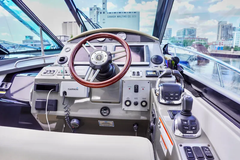  Yacht Photos Pics Cockpit of 2012 Regal 42 Sport Coupe with steering wheel and navigation controls.