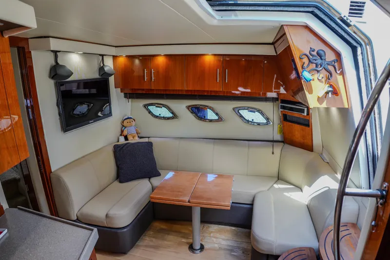  Yacht Photos Pics Luxurious interior of 2012 Regal 42 Sport Coupe with plush seating and modern decor.