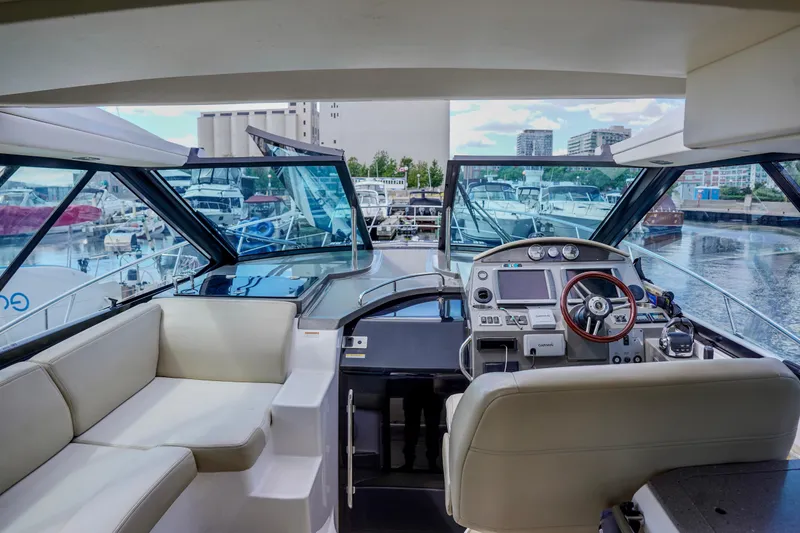  Yacht Photos Pics 2012 Regal 42 Sport Coupe yacht interior with helm, seating, and marina view.