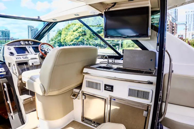  Yacht Photos Pics Interior of 2012 Regal 42 Sport Coupe yacht with helm, kitchen, and TV.