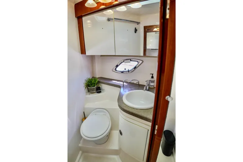  Yacht Photos Pics Luxurious bathroom in 2012 Regal 42 Sport Coupe yacht with modern fixtures and elegant design.