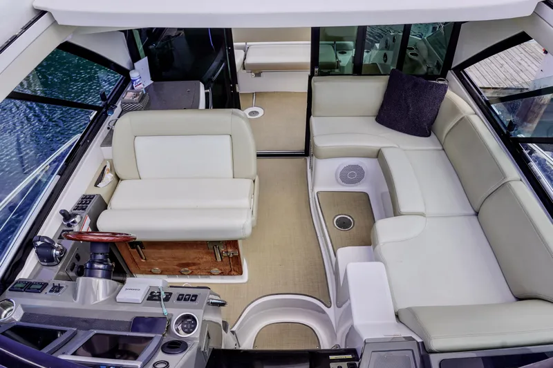  Yacht Photos Pics Luxurious interior of 2012 Regal 42 Sport Coupe with plush seating and modern helm.