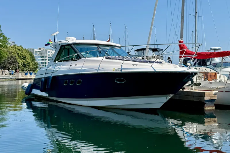  Yacht Photos Pics 2012 Regal 42 Sport Coupe yacht docked in marina, surrounded by other boats.