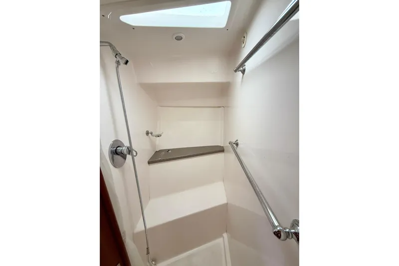  Yacht Photos Pics Shower area in 2012 Regal 42 Sport Coupe yacht with skylight and chrome fixtures.