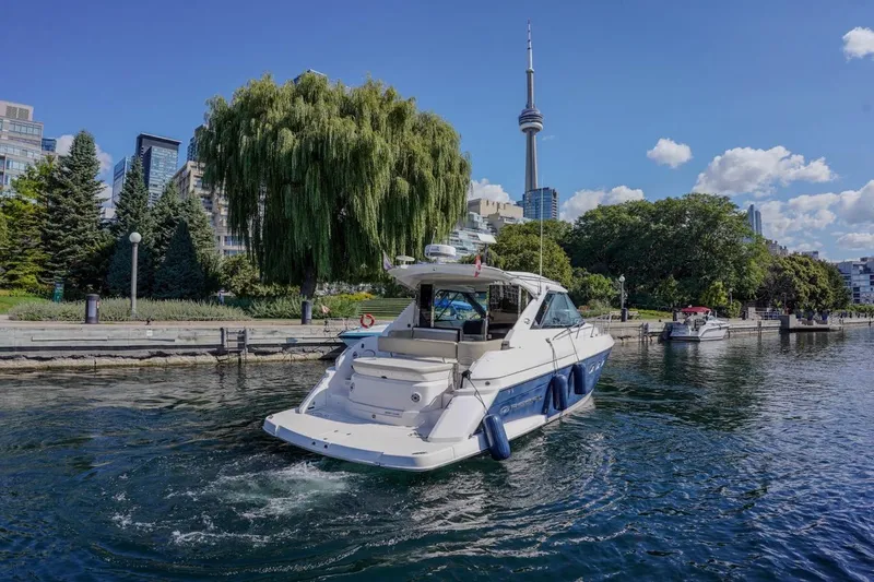  Yacht Photos Pics 2012 Regal 42 Sport Coupe yacht cruising near urban waterfront with CN Tower in background.