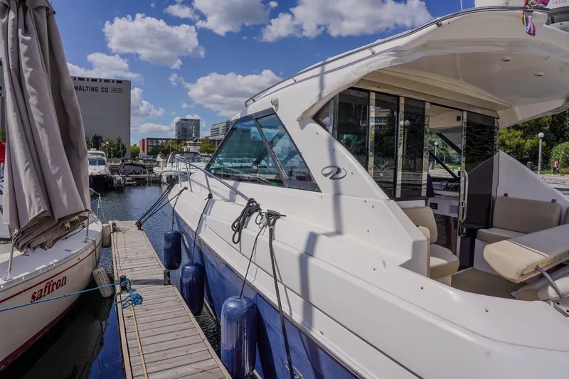  Yacht Photos Pics 2012 Regal 42 Sport Coupe docked at marina under blue sky.