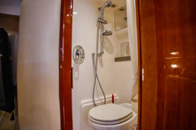  Yacht Photos Pics Bathroom interior of 2012 Regal 42 Sport Coupe yacht, featuring shower and toilet.