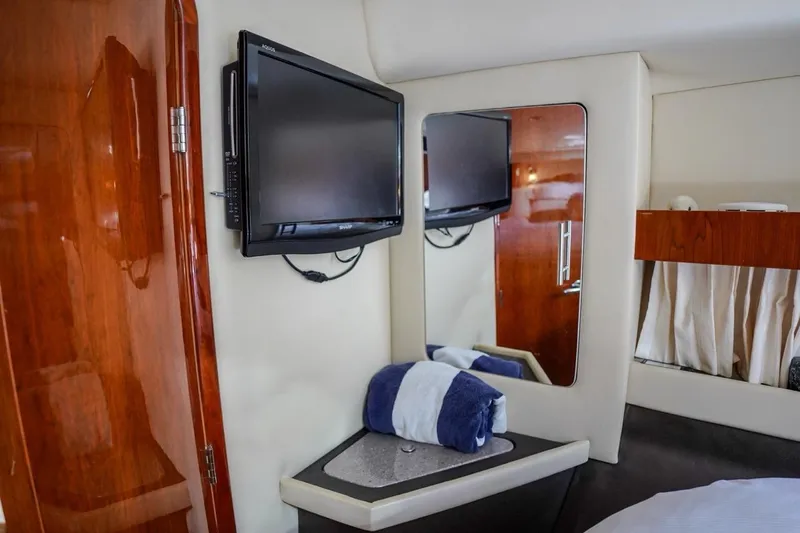  Yacht Photos Pics 2012 Regal 42 Sport Coupe interior with TV, mirror, and wooden accents.