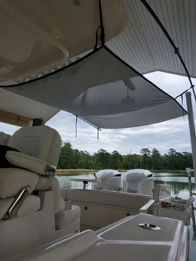 Yacht Photos Pics 2019 Jupiter 30 HFS boat interior with canopy, overlooking serene lake and trees.