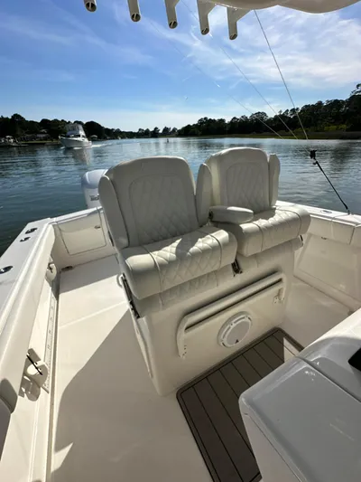  Yacht Photos Pics 2019 Jupiter 30 HFS boat interior with cushioned seating on a calm waterway.