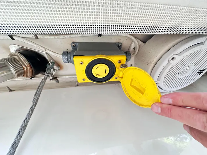  Yacht Photos Pics Yellow power outlet on a 2019 Jupiter 30 HFS boat, with hand opening cover.