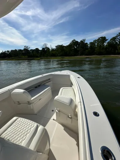  Yacht Photos Pics 2019 Jupiter 30 HFS boat interior with white seating, on calm water under blue sky.