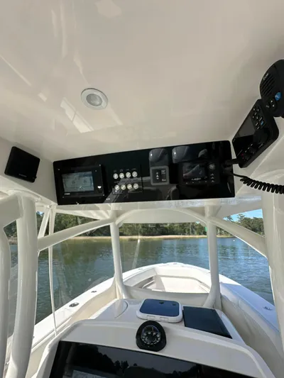  Yacht Photos Pics 2019 Jupiter 30 HFS boat console with navigation equipment on a calm water backdrop.