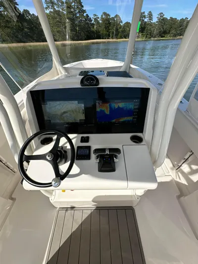  Yacht Photos Pics 2019 Jupiter 30 HFS boat helm with dual displays on a serene water backdrop.