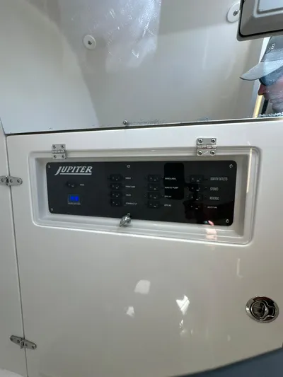  Yacht Photos Pics Control panel of a 2019 Jupiter 30 HFS boat, featuring various switches and indicators.