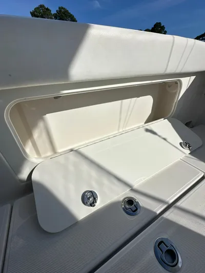  Yacht Photos Pics 2019 Jupiter 30 HFS boat storage compartment with open hatch under clear blue sky.