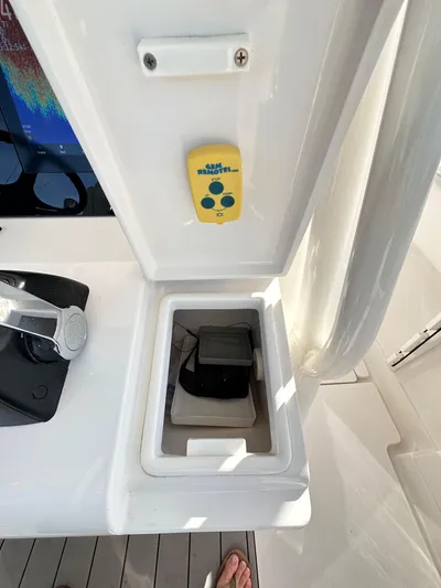  Yacht Photos Pics 2019 Jupiter 30 HFS boat console with storage compartment and remote control.