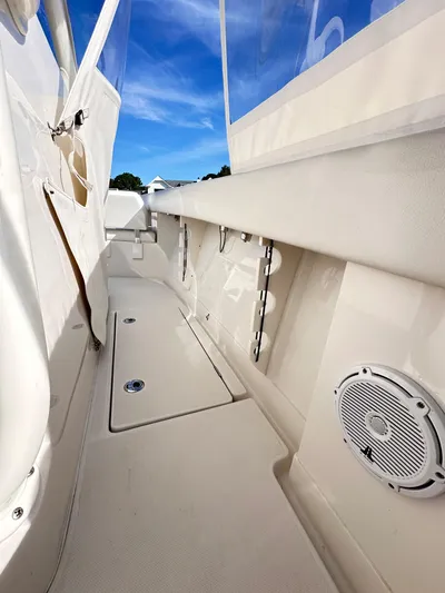  Yacht Photos Pics 2019 Jupiter 30 HFS boat interior with white seating and speaker, under clear blue sky.